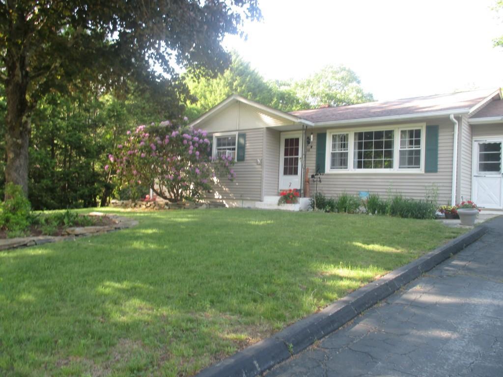 a front view of house with yard and green space