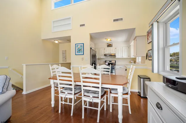 a dining room with furniture and wooden floor