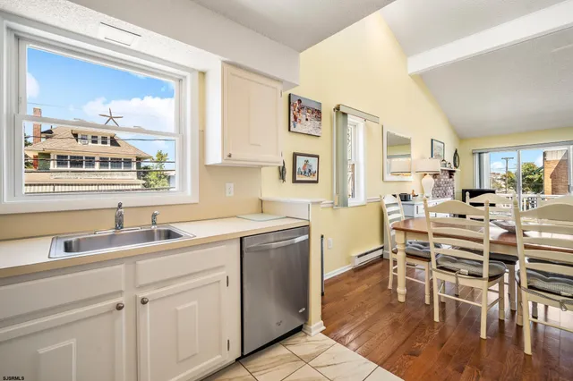 a kitchen with a table chairs stove and cabinets
