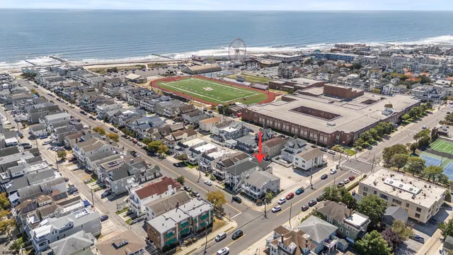 an aerial view of a city with ocean