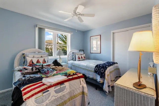 a bedroom with two beds and a chandelier