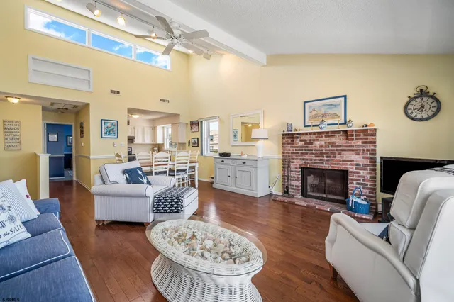 a living room with furniture fireplace and a table