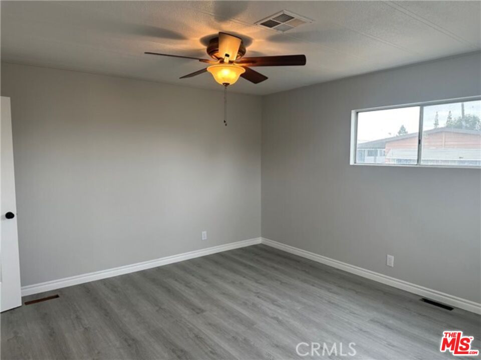 9391 California Avenue, Unit 89 Riverside, CA 92503 - Photo 7 of 16 an empty room with a window