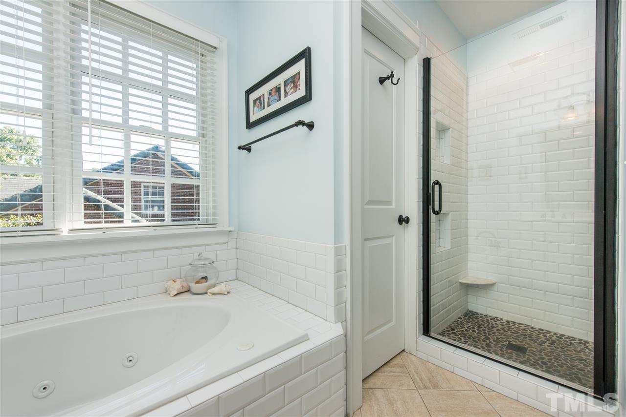 2218 Creston Road Raleigh, NC 27608 - Photo 16 of 25 a bathroom with a bathtub and a shower