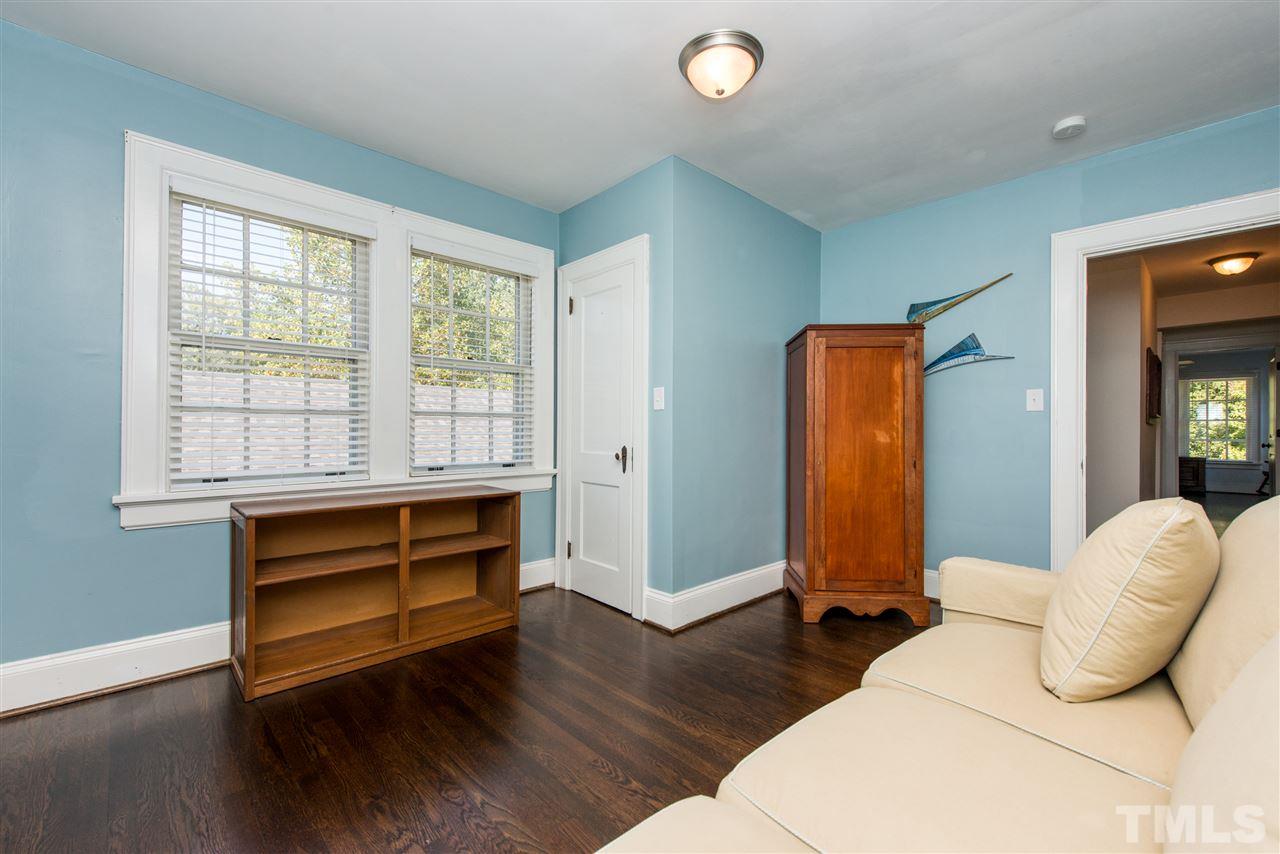 2218 Creston Road Raleigh, NC 27608 - Photo 20 of 25 a bedroom with bed and wooden floor