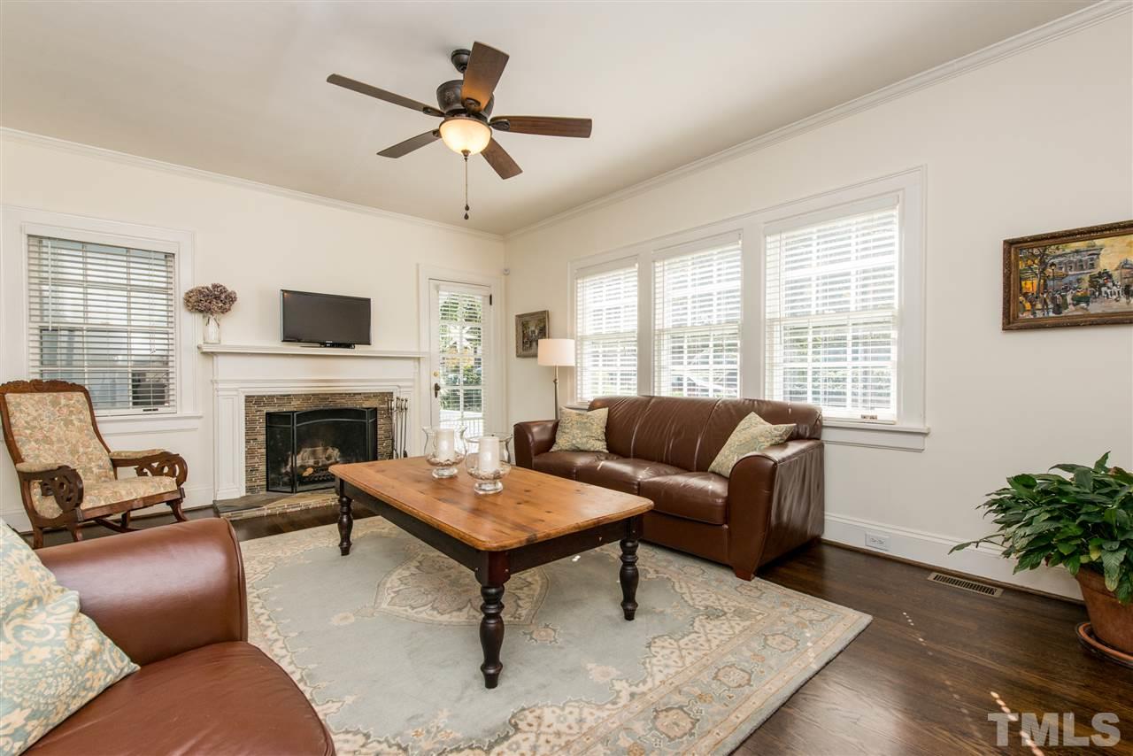 2218 Creston Road Raleigh, NC 27608 - Photo 3 of 25 a living room with furniture a fireplace and a potted plant