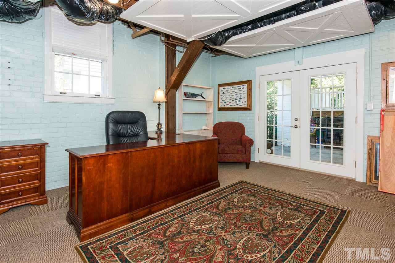 2218 Creston Road Raleigh, NC 27608 - Photo 22 of 25 a living room with furniture and a rug