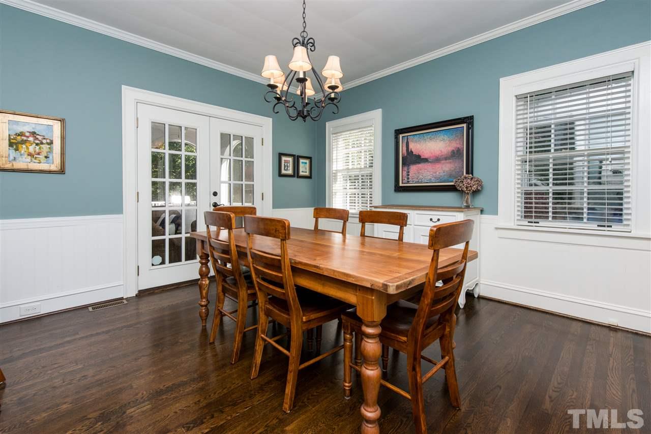 2218 Creston Road Raleigh, NC 27608 - Photo 5 of 25 a view of a dining room with furniture wooden floor and chandelier