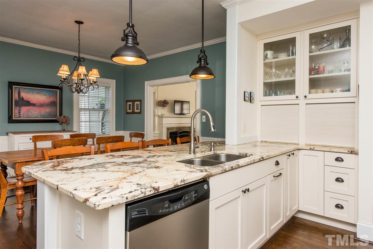 2218 Creston Road Raleigh, NC 27608 - Photo 8 of 25 a view of a kitchen center island and living room furniture