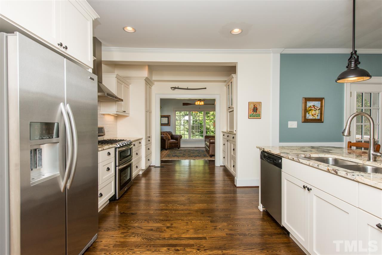 2218 Creston Road Raleigh, NC 27608 - Photo 9 of 25 a kitchen with stainless steel appliances a refrigerator and a sink