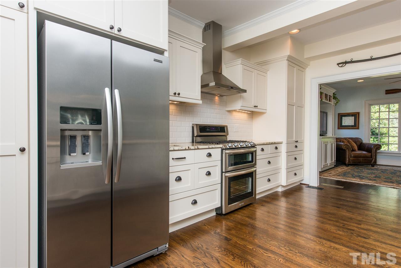 2218 Creston Road Raleigh, NC 27608 - Photo 10 of 25 a kitchen with stainless steel appliances a refrigerator sink and stove