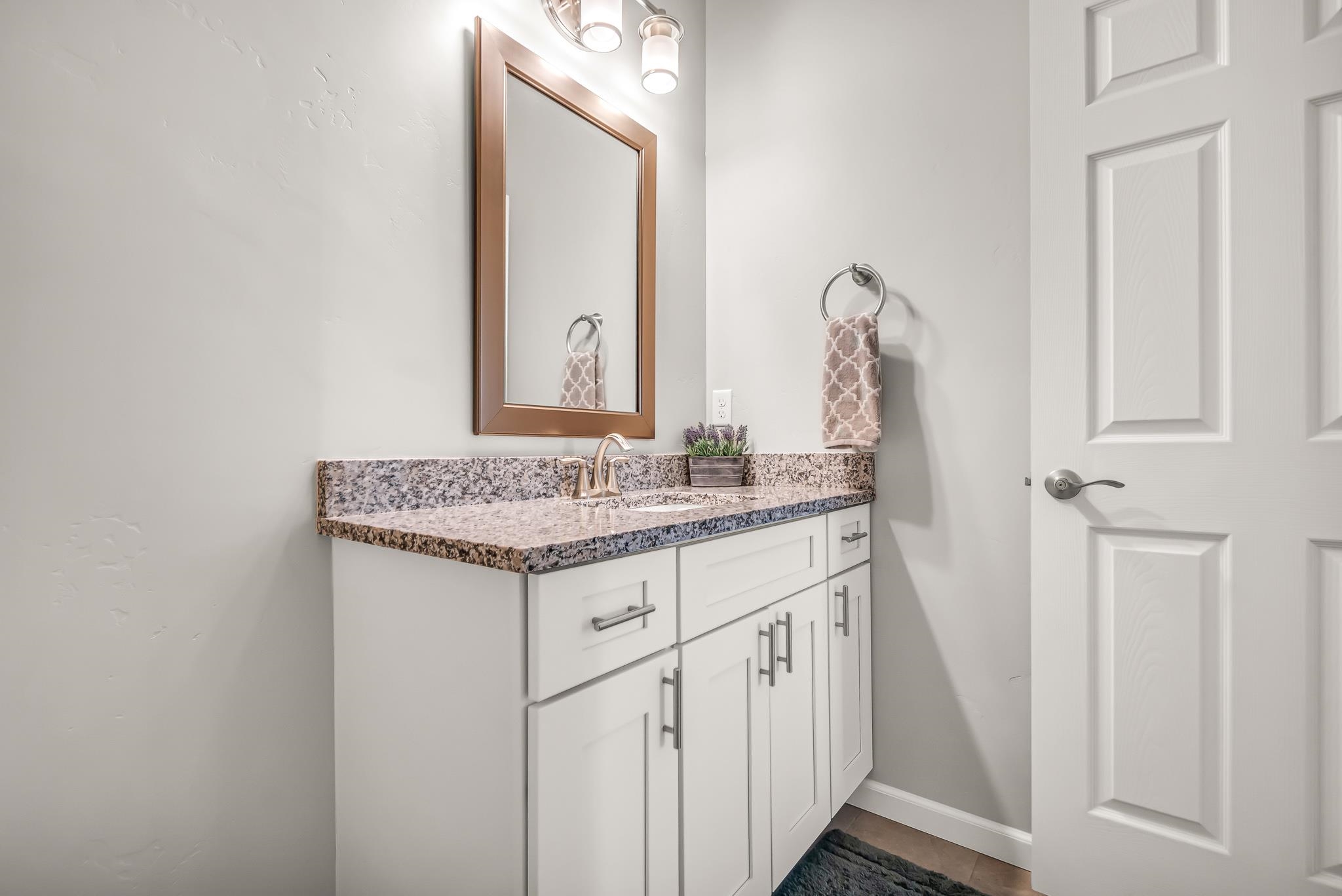 454 Lewis Street Grand Junction, CO 81504 - Photo 11 of 25 a bathroom with a granite countertop sink and a mirror