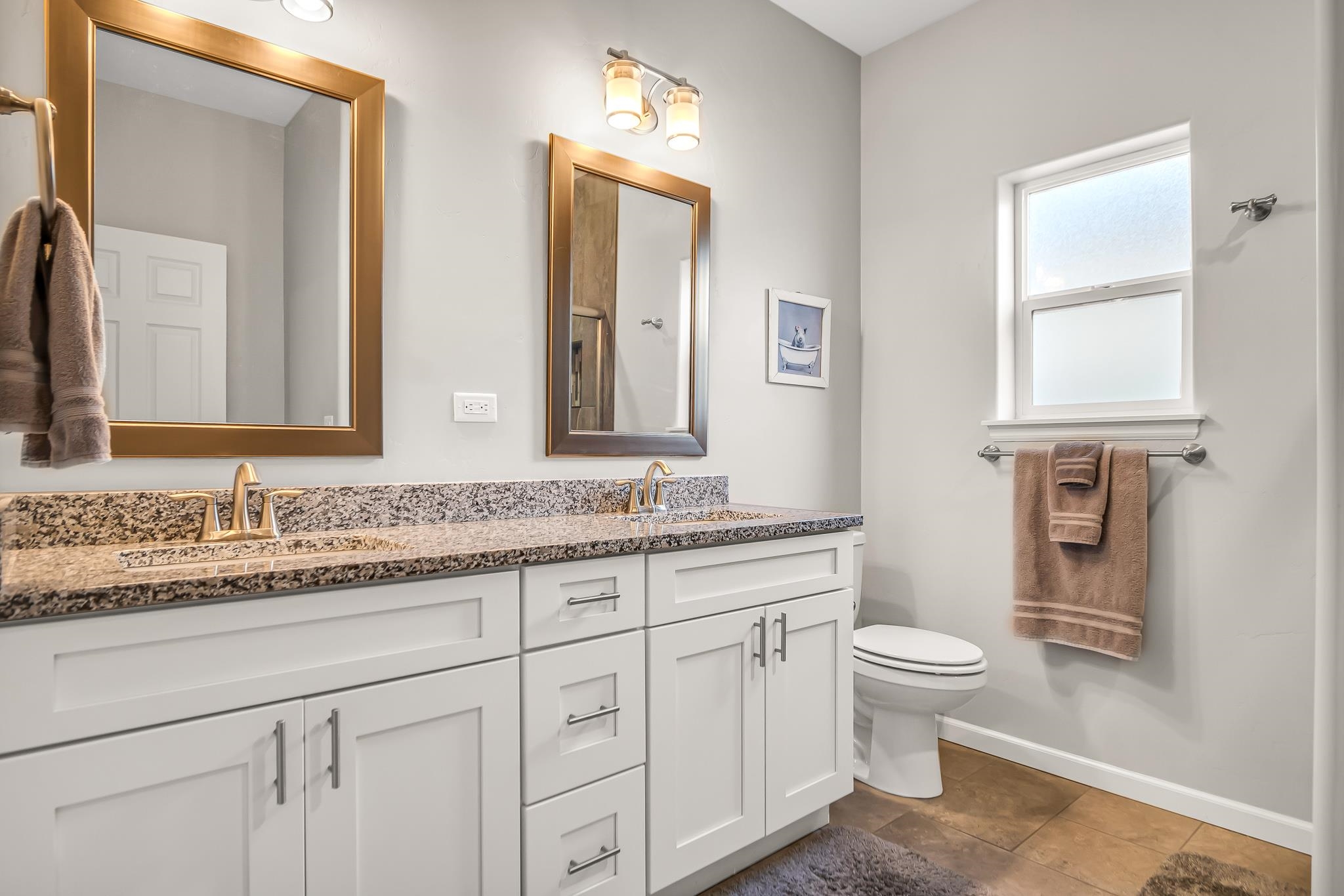 454 Lewis Street Grand Junction, CO 81504 - Photo 13 of 25 a bathroom with a granite countertop toilet sink and mirror
