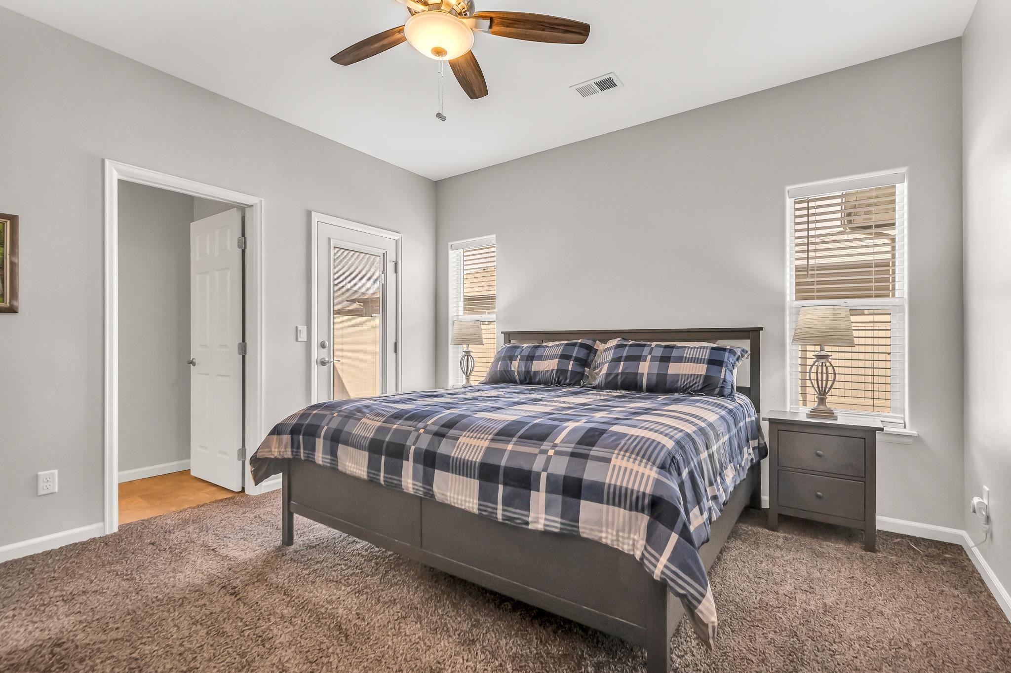 454 Lewis Street Grand Junction, CO 81504 - Photo 15 of 25 a bedroom with a large bed and a chandelier