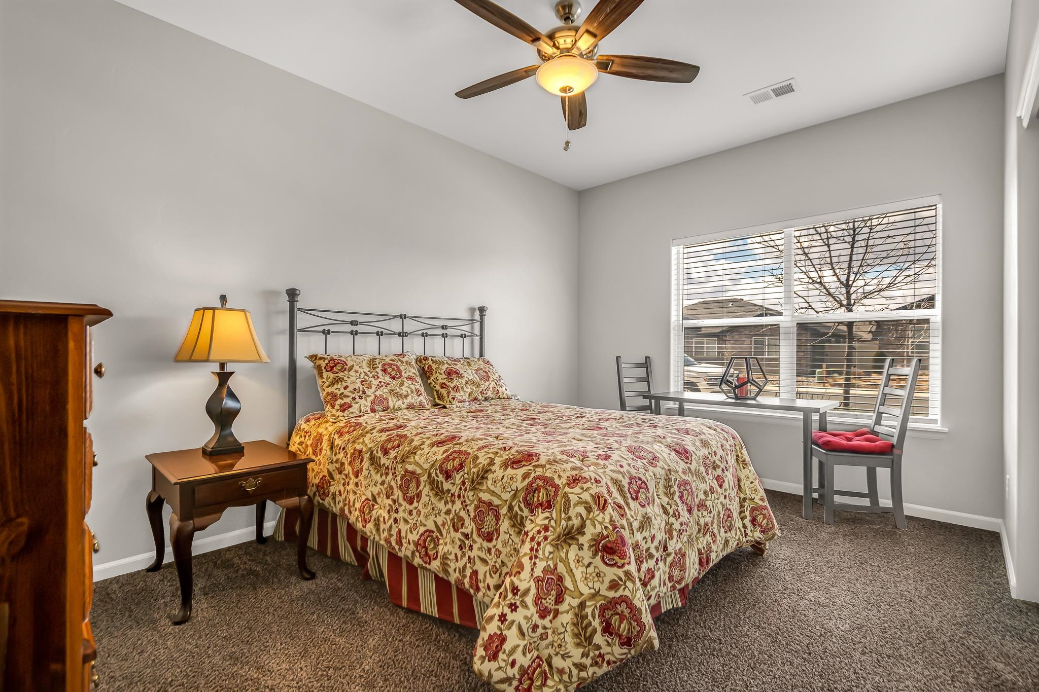 454 Lewis Street Grand Junction, CO 81504 - Photo 16 of 25 a bedroom with a bed and a chandelier