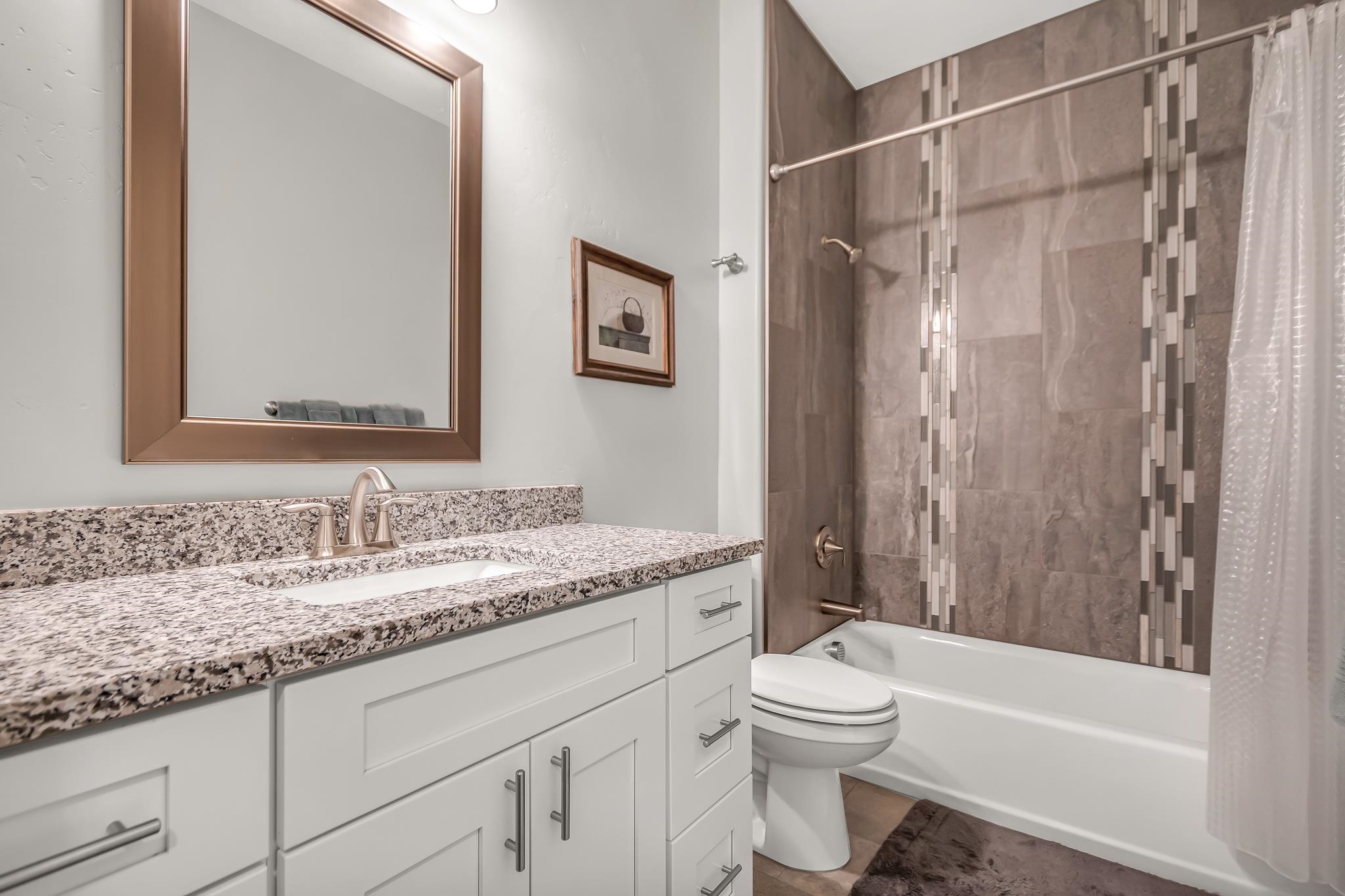 454 Lewis Street Grand Junction, CO 81504 - Photo 17 of 25 a bathroom with a granite countertop sink toilet and shower