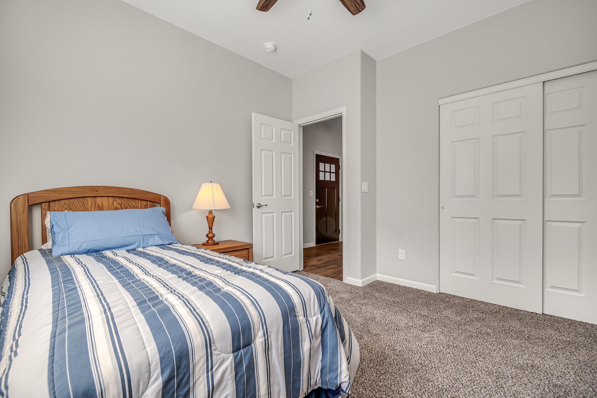 454 Lewis Street Grand Junction, CO 81504 - Photo 18 of 25 a bedroom with a bed and a lamp