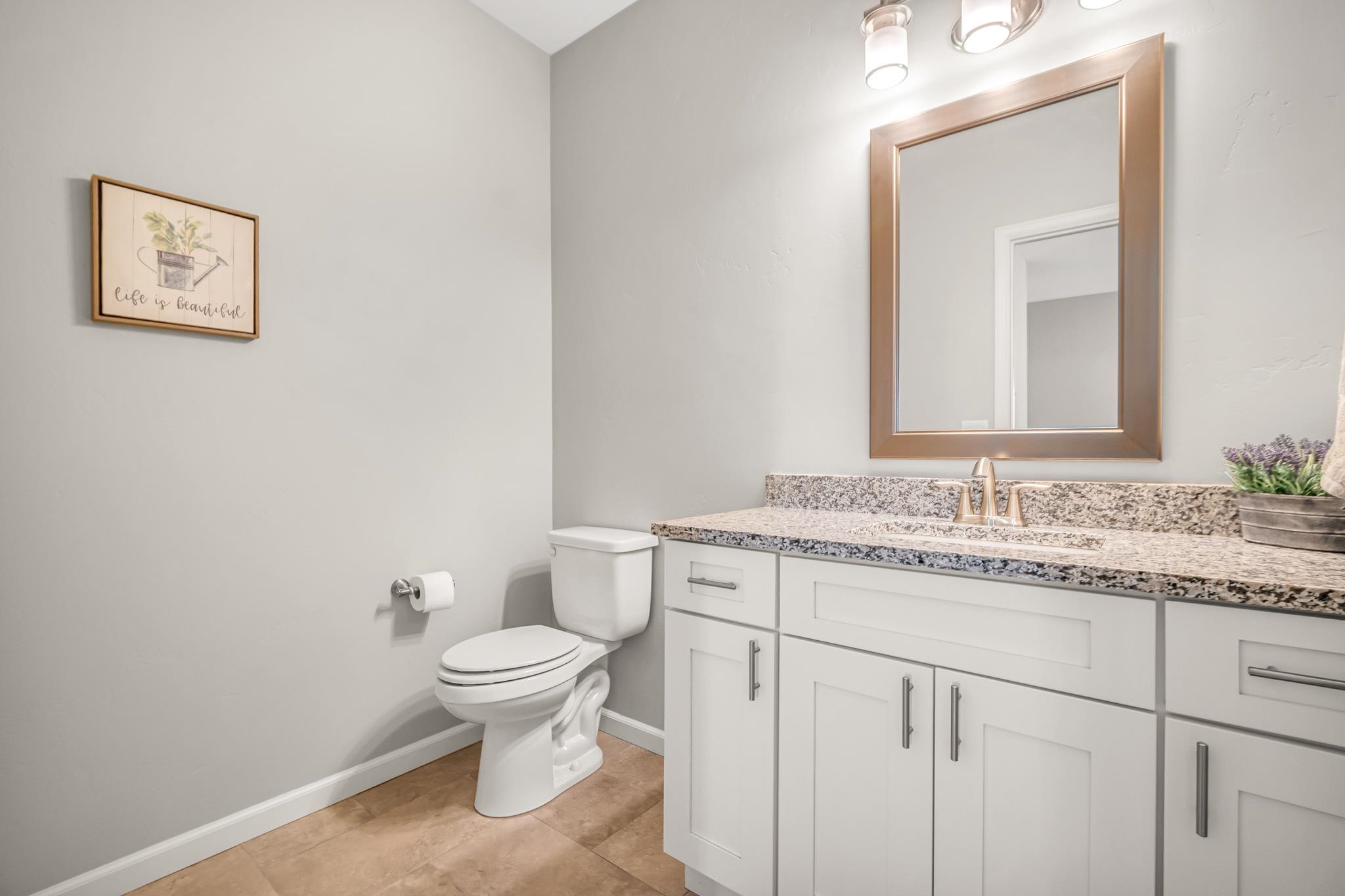 454 Lewis Street Grand Junction, CO 81504 - Photo 10 of 25 a bathroom with a granite countertop toilet a sink and a mirror