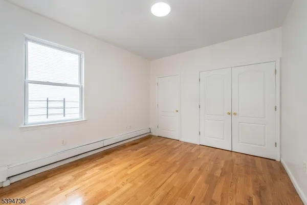 an empty room with a empty space and windows