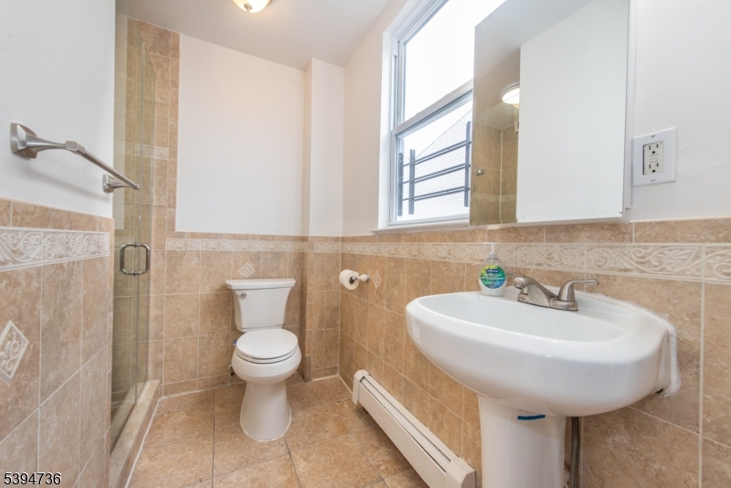263 South 10th Street Newark, NJ 07103 - Photo 17 of 22 a bathroom with a sink and a toilet