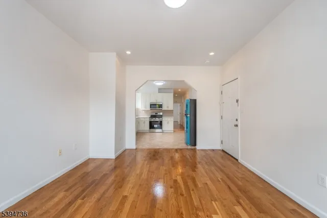 a view of a kitchen with wooden floor