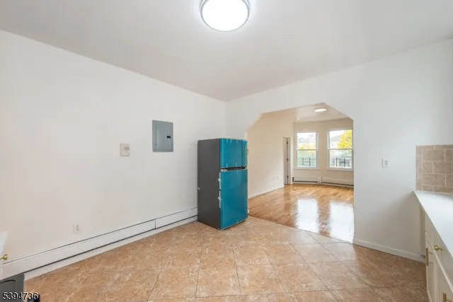 an empty room with entrance and windows