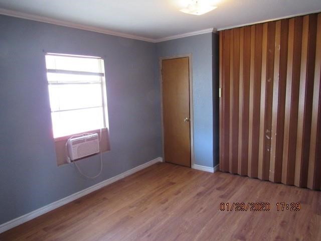 1563 18th Street, Unit A Corpus Christi, TX 78404 - Photo 11 of 15 an empty room with wooden floor and a window