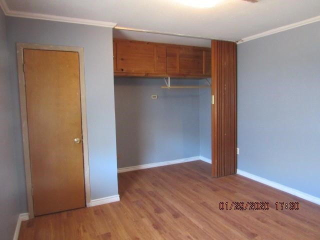 1563 18th Street, Unit A Corpus Christi, TX 78404 - Photo 12 of 15 a view of an empty room with wooden floor and closet