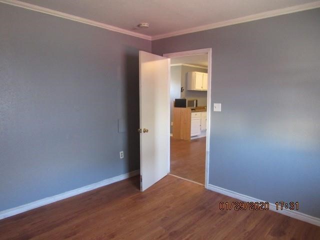 1563 18th Street, Unit A Corpus Christi, TX 78404 - Photo 13 of 15 an empty room with wooden floor and entrance