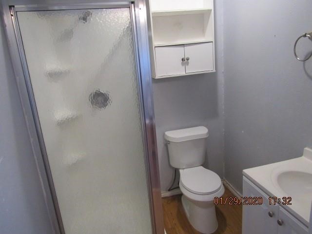 1563 18th Street, Unit A Corpus Christi, TX 78404 - Photo 14 of 15 a white toilet sitting next to a bathroom sink