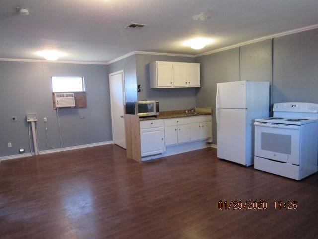 1563 18th Street, Unit A Corpus Christi, TX 78404 - Photo 3 of 15 a kitchen with granite countertop white cabinets and white appliances