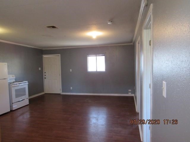 1563 18th Street, Unit A Corpus Christi, TX 78404 - Photo 6 of 15 an empty room with wooden floor and windows