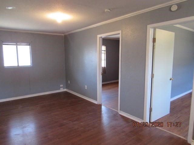 1563 18th Street, Unit A Corpus Christi, TX 78404 - Photo 7 of 15 an empty room with wooden floor and windows