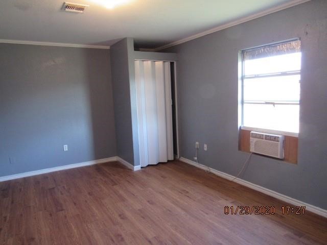 1563 18th Street, Unit A Corpus Christi, TX 78404 - Photo 8 of 15 an empty room with wooden floor and windows