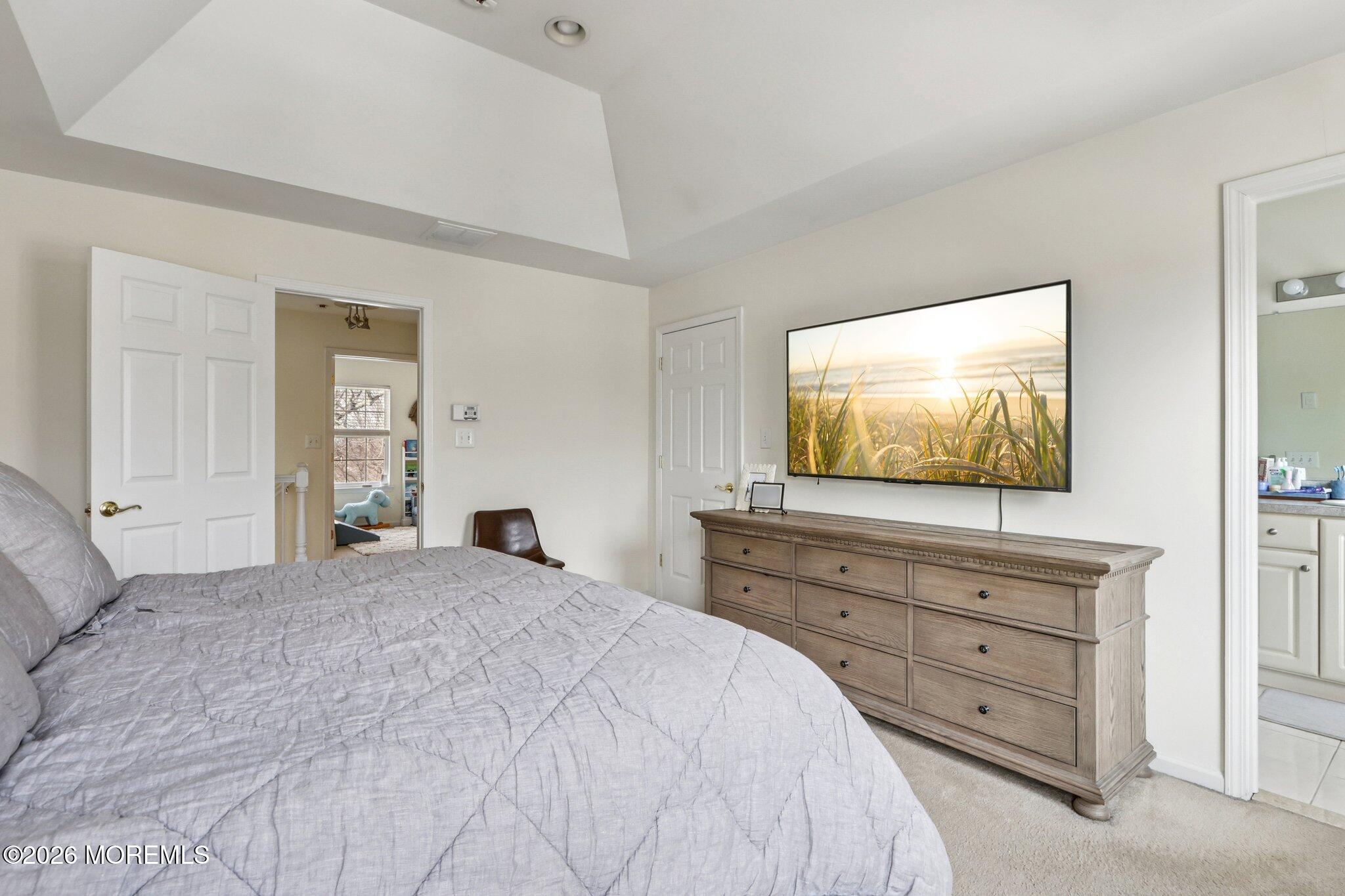 14 West Aspen Way Matawan, NJ 07747 - Photo 12 of 42 a bedroom with a bed and a flat screen tv