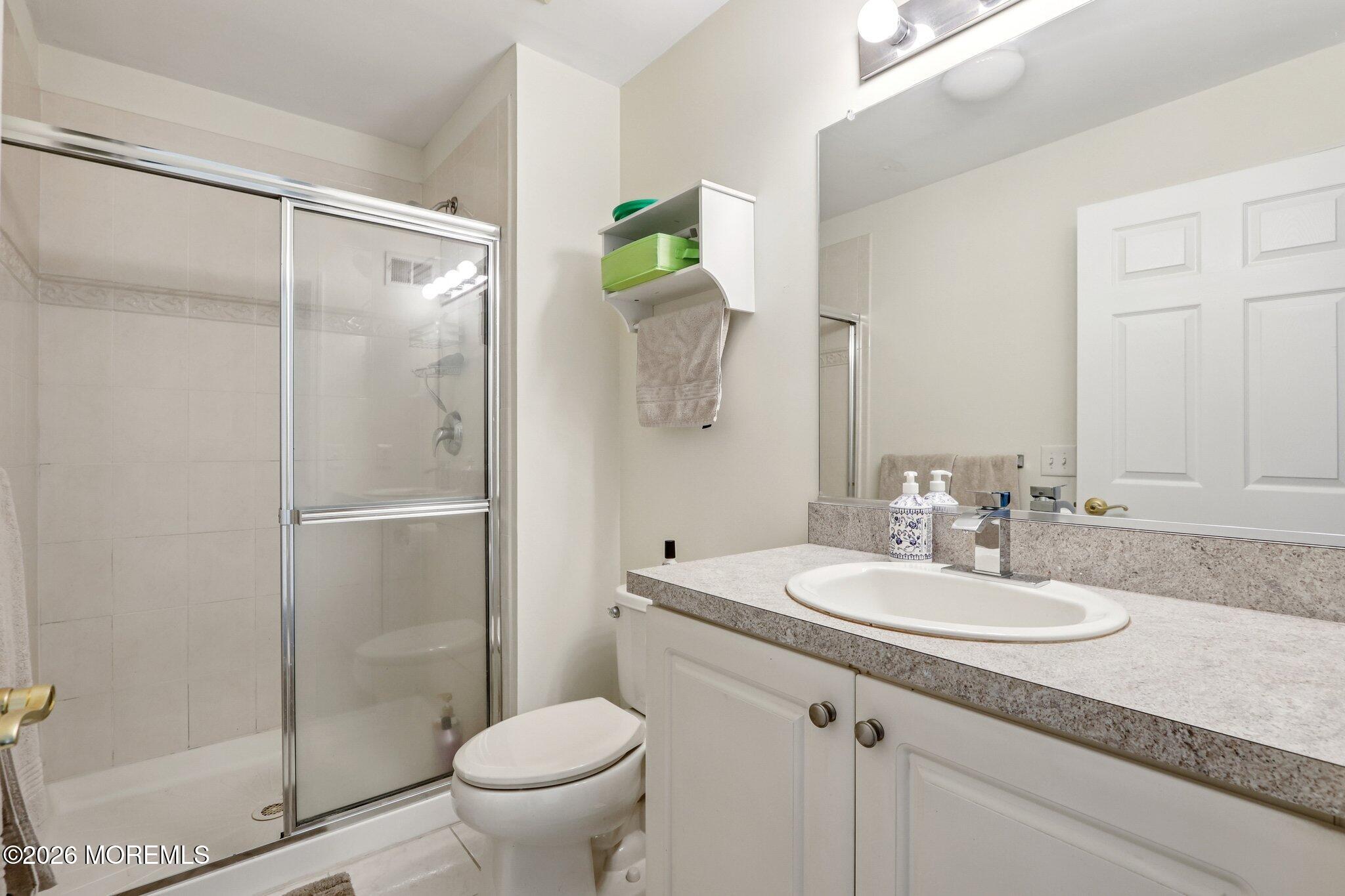14 West Aspen Way Matawan, NJ 07747 - Photo 13 of 42 a bathroom with a granite countertop sink toilet and shower