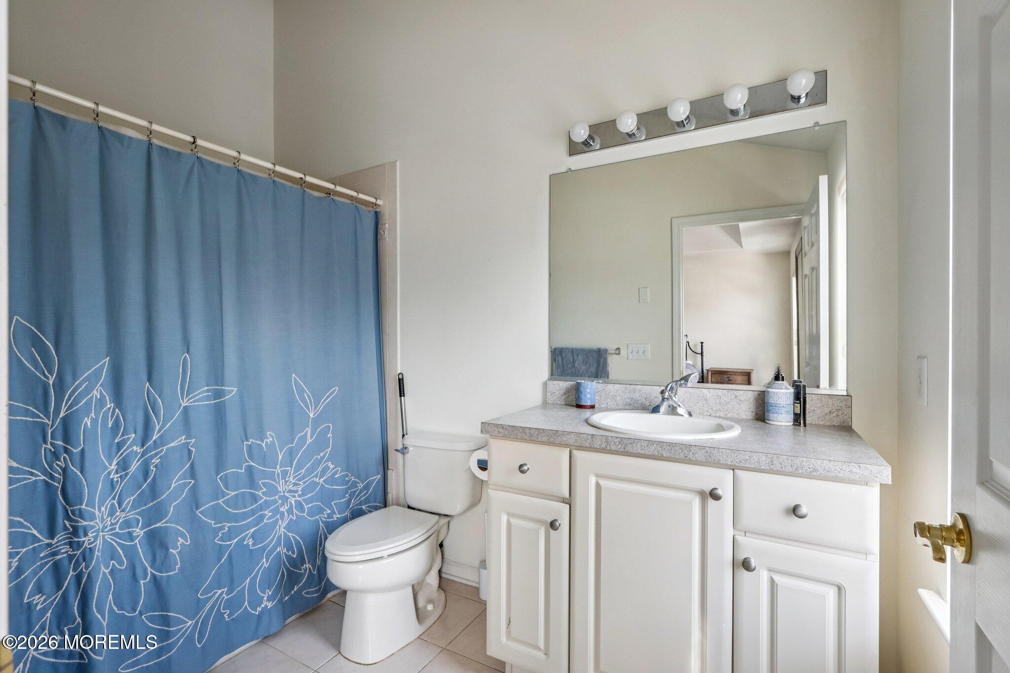 14 West Aspen Way Matawan, NJ 07747 - Photo 19 of 46 a bathroom with a granite countertop sink toilet and mirror
