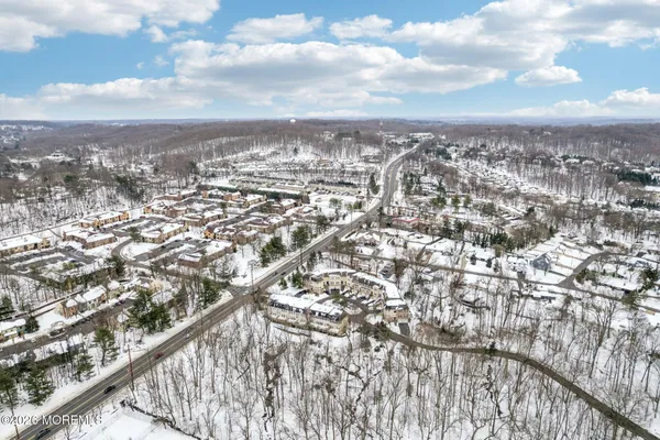 an aerial view of residential building with yard