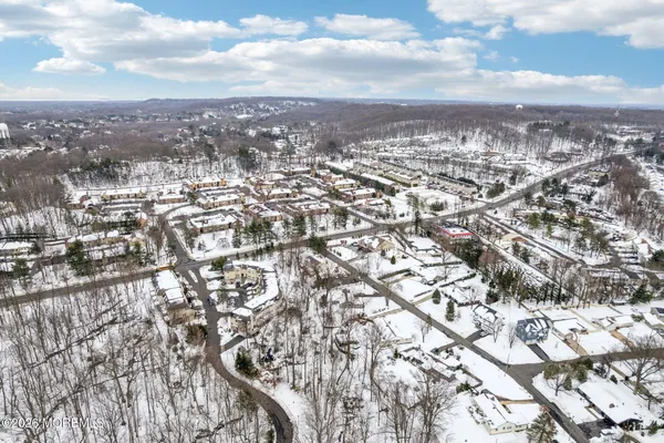an aerial view of residential building with yard