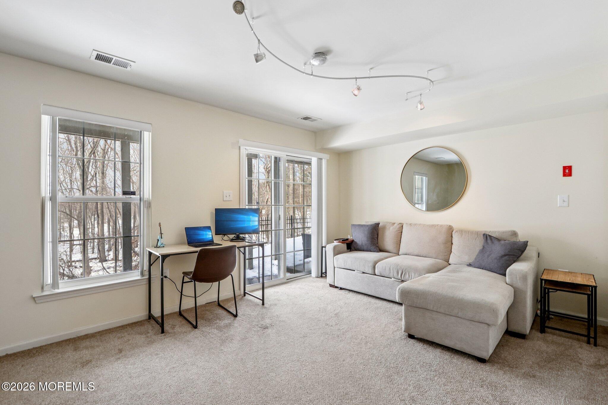 14 West Aspen Way Matawan, NJ 07747 - Photo 23 of 46 a living room with furniture and a large window
