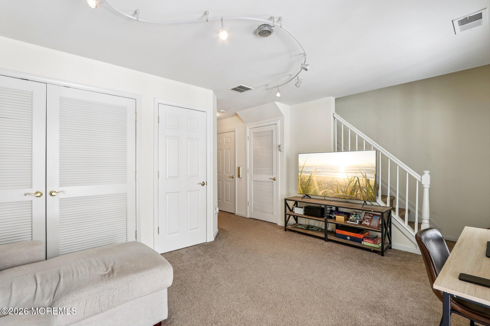 14 West Aspen Way Matawan, NJ 07747 - Photo 28 of 42 a living room with furniture and a flat screen tv