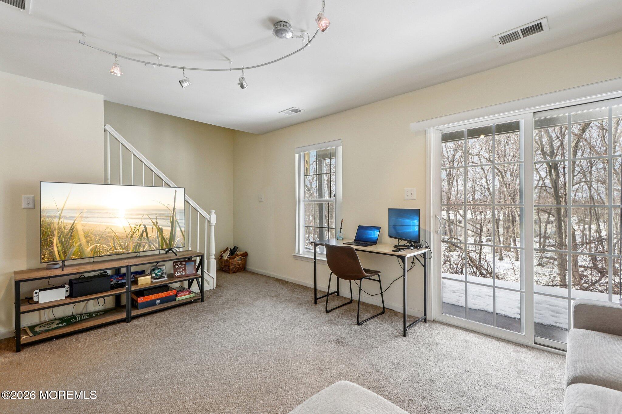 14 West Aspen Way Matawan, NJ 07747 - Photo 32 of 42 a living room with furniture and a flat screen tv