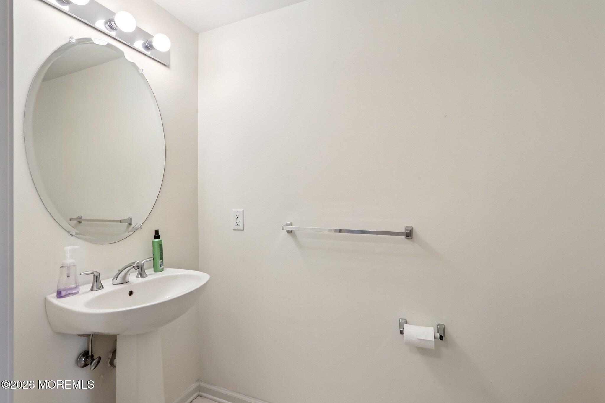 14 West Aspen Way Matawan, NJ 07747 - Photo 34 of 42 a bathroom with a sink a mirror and vanity