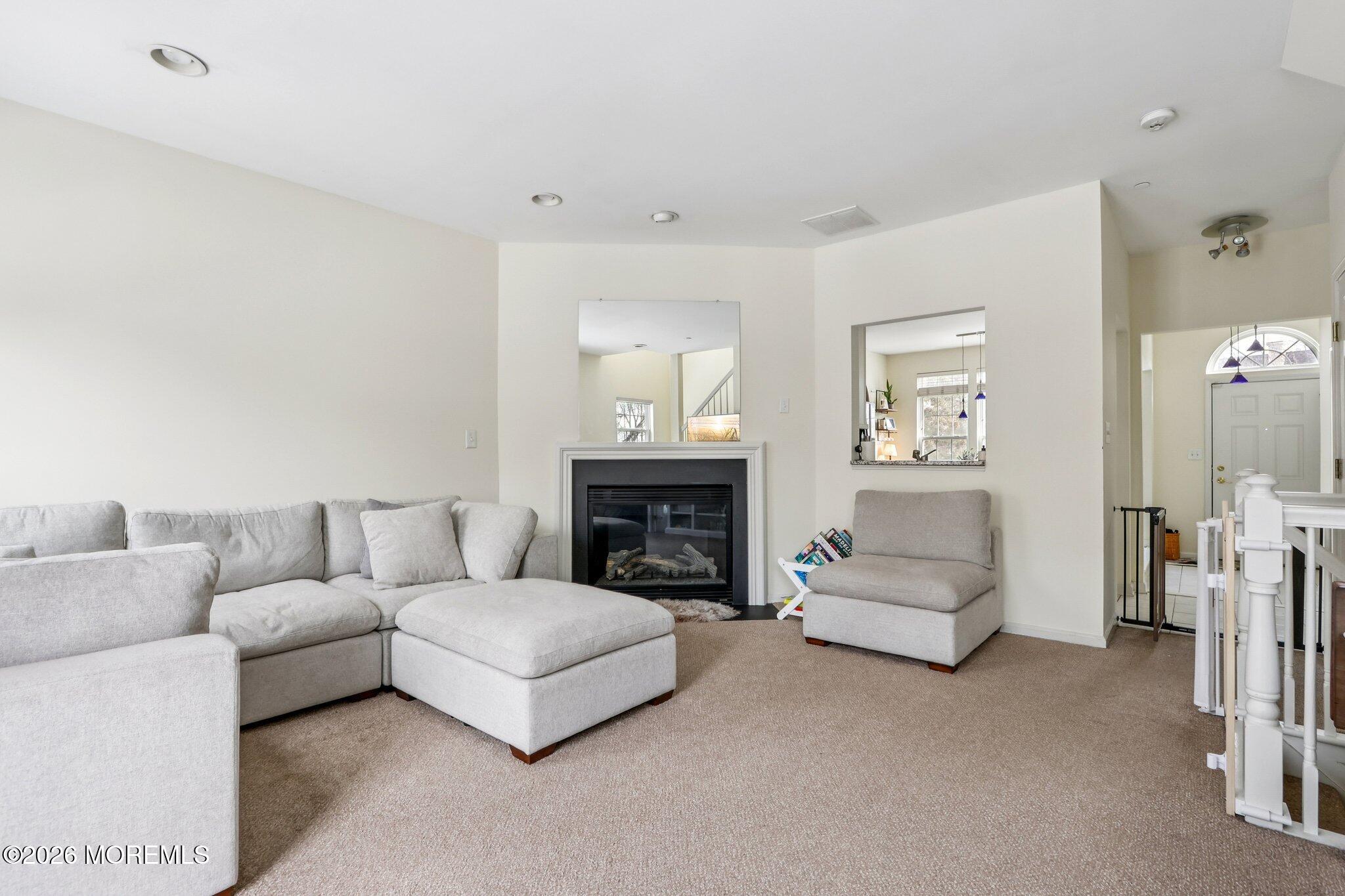 14 West Aspen Way Matawan, NJ 07747 - Photo 7 of 46 a living room with furniture and a fireplace