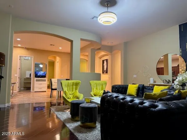 a living room with couches and painting on the wall