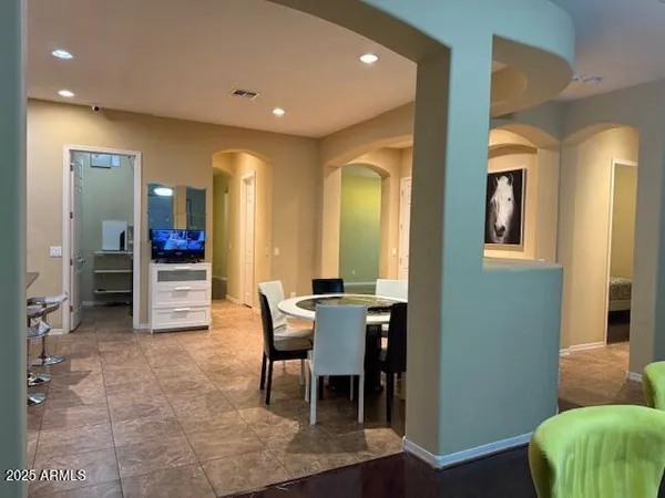a living room with furniture and mirror