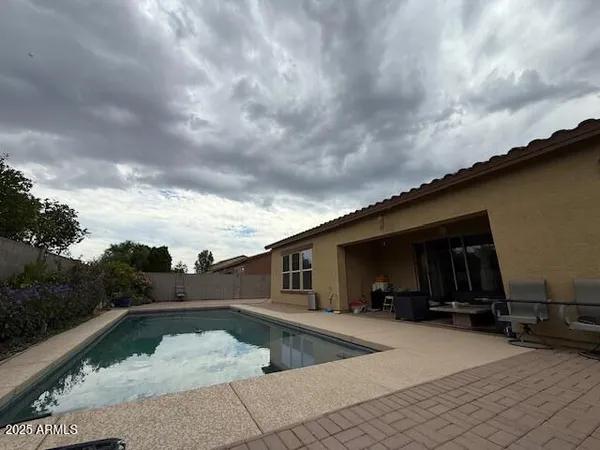 a view of backyard of house with car parked