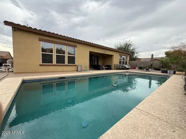 a view of a swimming pool with a yard