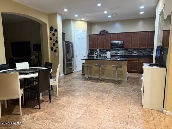 a large kitchen with a table and chairs