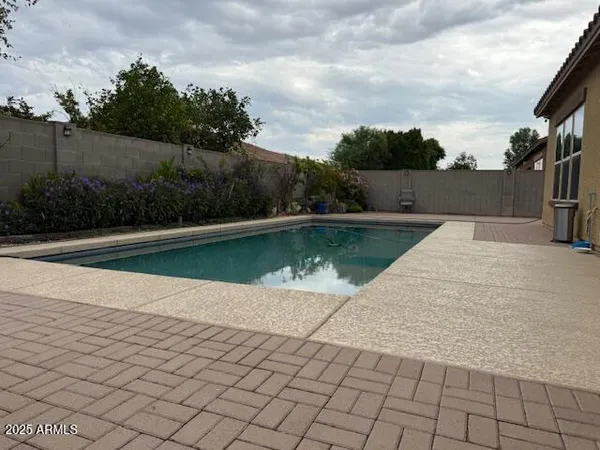 a view of a patio with chairs and potted plants